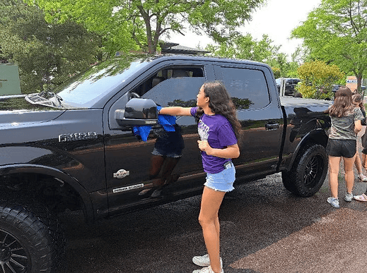 Cheerleaders washing cars